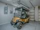 Close-up view of golf cart parked inside clean, well-lit garage with epoxy floors at 1419 Arbor Trl, The Villages, FL 32162