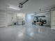 A clean, spacious garage with a utility sink, washer/dryer, and golf cart at 1419 Arbor Trl, The Villages, FL 32162
