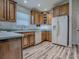 Spacious kitchen offers ample counter space, wood cabinetry, and modern white appliances, creating a functional cooking area at 1419 Arbor Trl, The Villages, FL 32162