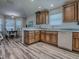 Bright kitchen features wood cabinets, subway tile backsplash, and modern appliances overlooking the dining area at 1419 Arbor Trl, The Villages, FL 32162