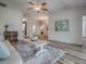 Inviting living room showcasing wood floors, neutral paint, and a cozy, open layout at 1419 Arbor Trl, The Villages, FL 32162