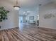 Spacious living room featuring wood floors, neutral paint, and an open floor plan at 1419 Arbor Trl, The Villages, FL 32162