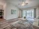 Open living room featuring sliding glass doors, hardwood flooring, and a ceiling fan at 1419 Arbor Trl, The Villages, FL 32162