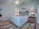 Relaxing main bedroom highlights a decorative headboard, matching nightstands, and stylish accents, offering a comfortable space at 1419 Arbor Trl, The Villages, FL 32162