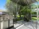 Outdoor kitchen area with a stainless steel grill and a view of the yard at 1419 Arbor Trl, The Villages, FL 32162