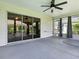 Covered lanai with ceiling fan and access to the interior through sliding glass doors at 1419 Arbor Trl, The Villages, FL 32162