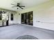 A covered patio features a ceiling fan, stainless steel grill, and easy access to the interior through sliding glass doors at 1419 Arbor Trl, The Villages, FL 32162