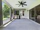 Spacious screened patio with ceiling fan, outdoor grill, and view of the landscaped backyard at 1419 Arbor Trl, The Villages, FL 32162