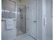 Modern shower with glass enclosure and towel rack in a bright bathroom with tile flooring at 1419 Arbor Trl, The Villages, FL 32162