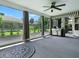 Outdoor sunroom featuring an outdoor kitchen, ceiling fan, and view of the garden at 1419 Arbor Trl, The Villages, FL 32162