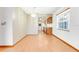 Bright dining room boasts a chandelier, wood-look floors, and view into the kitchen at 1467 Disston Ave, Clermont, FL 34711