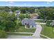 Aerial view of the property nestled in a community surrounded by mature trees with a long driveway at 14708 Timucua Pl, Clermont, FL 34711