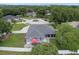 A high angle backyard view displays the patio, home and meticulously kept yard at 14708 Timucua Pl, Clermont, FL 34711