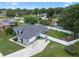 Aerial view showcasing the home's layout, long driveway, fenced backyard, and mature trees surrounding the property at 14708 Timucua Pl, Clermont, FL 34711