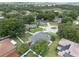 Aerial view of a community with lush landscaping, manicured lawns, and tranquil streets showing the property and its surroundings at 14708 Timucua Pl, Clermont, FL 34711