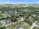 The aerial view displays a neighborhood featuring ponds, tree-lined streets, manicured lawns, and a serene environment at 14708 Timucua Pl, Clermont, FL 34711