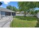 Lush backyard features a walkway, mature trees, and a privacy fence providing a peaceful retreat at 14708 Timucua Pl, Clermont, FL 34711