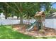 Beautiful backyard featuring a wooden playset and lush green space, perfect for outdoor enjoyment at 14708 Timucua Pl, Clermont, FL 34711