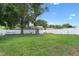 Expansive backyard featuring lush green grass, a white privacy fence, and a charming playground at 14708 Timucua Pl, Clermont, FL 34711