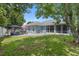 Spacious backyard with lush lawn, patio area, and well-maintained landscaping provides serene outdoor living at 14708 Timucua Pl, Clermont, FL 34711