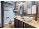 Modern bathroom featuring double sinks, granite countertops, and stylish fixtures at 14708 Timucua Pl, Clermont, FL 34711