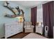 Light and airy Bedroom featuring a white dresser and chair, and stylish decor at 14708 Timucua Pl, Clermont, FL 34711