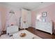 Adorable pink bedroom featuring a canopy bed, soft rug, and white furniture at 14708 Timucua Pl, Clermont, FL 34711