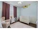 Cozy Bedroom with sunflower accents, comfortable chair, and white furniture at 14708 Timucua Pl, Clermont, FL 34711