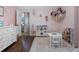 Charming bedroom with pink walls, a play kitchen, and hardwood floors at 14708 Timucua Pl, Clermont, FL 34711