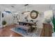 Dining room with wood floors, decorative rug, elegant table setting and striking overhead light fixture at 14708 Timucua Pl, Clermont, FL 34711
