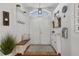 Bright entryway featuring double doors, a bench with storage, and decorative wall accents at 14708 Timucua Pl, Clermont, FL 34711