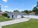 Exterior view of the single Gathering home with a long driveway, landscaped front yard, and white fence at 14708 Timucua Pl, Clermont, FL 34711