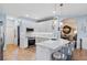Bright kitchen features white cabinets, quartz counters and stainless steel appliances at 14708 Timucua Pl, Clermont, FL 34711