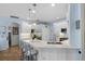 Modern kitchen with white cabinetry, stainless steel appliances, and a stylish breakfast bar at 14708 Timucua Pl, Clermont, FL 34711