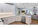 Well-lit kitchen with stainless steel appliances, quartz counters, and backyard view at 14708 Timucua Pl, Clermont, FL 34711
