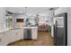 Open-concept kitchen with stainless steel appliances, island, and adjacent living area at 14708 Timucua Pl, Clermont, FL 34711