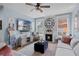 Stylish living room with TV, fireplace, ceiling fan, sofa, and view to backyard at 14708 Timucua Pl, Clermont, FL 34711