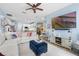 Open living room featuring a comfortable sectional sofa, large TV, and modern furnishings at 14708 Timucua Pl, Clermont, FL 34711