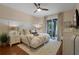 Cozy bedroom with natural light, ceiling fan and access to the lanai at 14708 Timucua Pl, Clermont, FL 34711