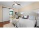 Bedroom with a ceiling fan and a sliding barn door leading to the bathroom at 14708 Timucua Pl, Clermont, FL 34711