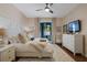 Bright bedroom with a ceiling fan and lanai access at 14708 Timucua Pl, Clermont, FL 34711
