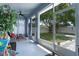 Screened-in patio overlooking a well-maintained backyard, complete with privacy fence and green grass at 14708 Timucua Pl, Clermont, FL 34711