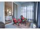 Relaxing patio with comfortable seating, privacy curtains, and sliding glass doors to the bedroom at 14708 Timucua Pl, Clermont, FL 34711