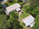 Aerial view of the property featuring the house, a backyard with a patio set, shed, and mature trees at 1537 Ne 22Nd St, Ocala, FL 34470