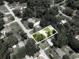 An aerial view of a single Gathering home surrounded by lush trees and a white privacy fence at 1537 Ne 22Nd St, Ocala, FL 34470
