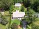 Aerial view of the property showing the house, shed, lush greenery, and layout of the front and back yards at 1537 Ne 22Nd St, Ocala, FL 34470