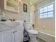 Well-lit bathroom featuring a shower-tub combo with white tile and clean fixtures at 1537 Ne 22Nd St, Ocala, FL 34470
