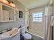 Well-lit bathroom featuring a shower-tub combo with white tile and clean fixtures at 1537 Ne 22Nd St, Ocala, FL 34470