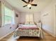 Comfortable bedroom with hardwood floors, ceiling fan, and a floral comforter at 1537 Ne 22Nd St, Ocala, FL 34470