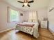 Comfortable bedroom with hardwood floors, ceiling fan, and a floral comforter at 1537 Ne 22Nd St, Ocala, FL 34470